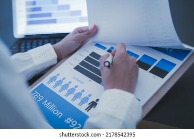 Business Woman Reviewing Data In Financial Charts And Graphs On Wooden Desk In Office And Business Working, Tax, Accounting, Statistics And Analytic Research Concept