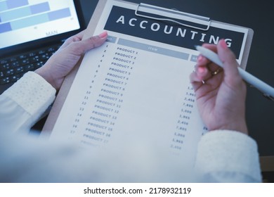 Business Woman Reviewing Data In Financial Charts And Graphs On Wooden Desk In Office And Business Working, Tax, Accounting, Statistics And Analytic Research Concept