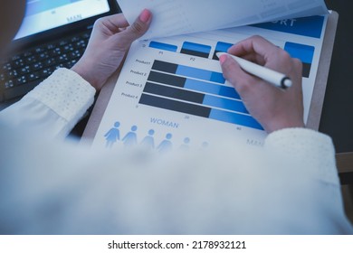 Business Woman Reviewing Data In Financial Charts And Graphs On Wooden Desk In Office And Business Working, Tax, Accounting, Statistics And Analytic Research Concept