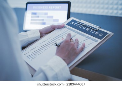 Business Woman Reviewing Data In Financial Charts And Graphs On Wooden Desk In Office And Business Working, Tax, Accounting, Statistics And Analytic Research Concept