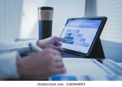 Business Woman Reviewing Data In Financial Charts And Graphs On Wooden Desk In Office And Business Working, Tax, Accounting, Statistics And Analytic Research Concept