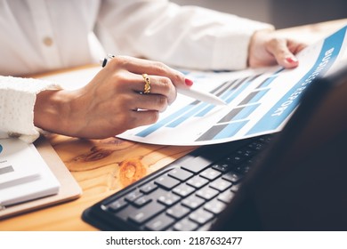 Business Woman Reviewing Data In Financial Charts And Graphs On Wooden Desk In Office And Business Working, Tax, Accounting, Statistics And Analytic Research Concept