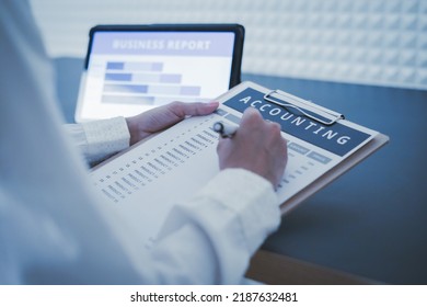 Business Woman Reviewing Data In Financial Charts And Graphs On Wooden Desk In Office And Business Working, Tax, Accounting, Statistics And Analytic Research Concept