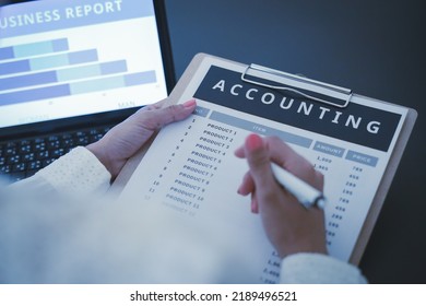 Business Woman Reviewing Data In Financial Charts And Graphs On Wooden Desk In Office And Business Working, Tax, Accounting, Statistics And Analytic Research Concept