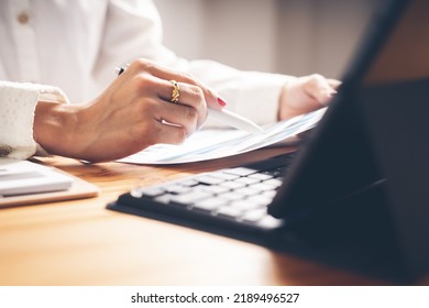 Business Woman Reviewing Data In Financial Charts And Graphs On Wooden Desk In Office And Business Working, Tax, Accounting, Statistics And Analytic Research Concept