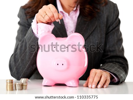 Business woman saving money in a piggybank - isolated