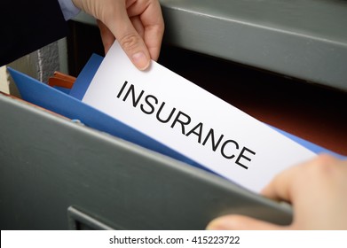 Business Woman Seeking An Insurance Policy In A Filing Cabinet