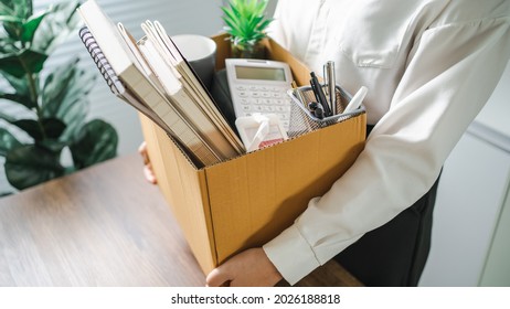 Business Woman Sending Resignation Letter And Packing Stuff Resign Depress Or Carrying Business Cardboard Box By Desk In Office. Change Of Job Or Fired From Company.