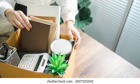 Geschäftsfrau schickt Rücktrittsbrief und packt Stuff Resign Depress oder befördert Business-Karton mit Schreibtisch im Büro. Arbeitsplatzwechsel oder Unternehmenswechsel.