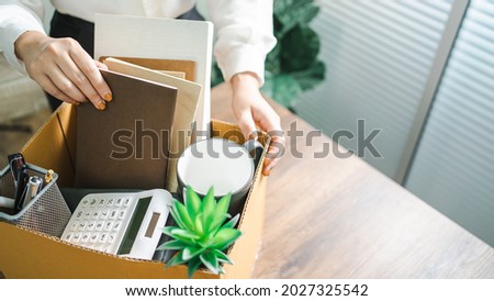 Business woman sending resignation letter and packing Stuff Resign Depress or carrying business cardboard box by desk in office. Change of job or fired from company. Foto d'archivio © 