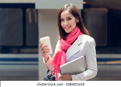 Business Woman She Is Going To Work In Her Morning At The Subway. And She Is Eating Coffee