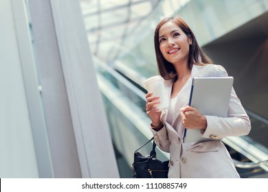 Business Woman She Is Going To Work In Her Morning At The Subway. And She Is Eating Coffee