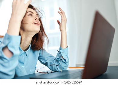 Business woman sitting at the computer with arms raised and workplace - Shutterstock ID 1427315594