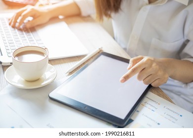 Business Woman Sitting At Home Working With IPad And Coffee Cup On The Desk, Business Concept.