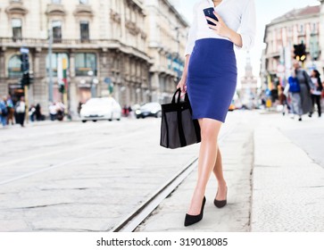 A Business Woman With Smart Phone Walking In The Street. Beautiful Legs With Office Fashion. Bag And Shoes In The City.