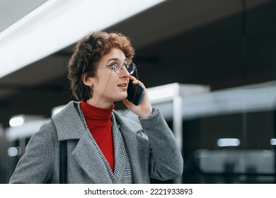 Business Woman With A Smartphone Waiting For A Train On The Subway Platform.