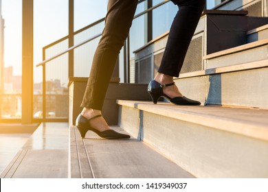 Business Woman Up The Stairs. Female Legs In High Heels Shoes Walking On The Stairs.