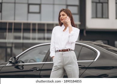 Business Woman Standing By The Car And Using Phone