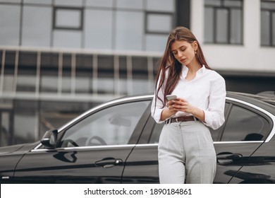 Business Woman Standing By The Car And Using Phone