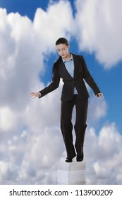 Business Woman Standing On A Very Large Stack Of Paper Work, Going High Up Into A Sky