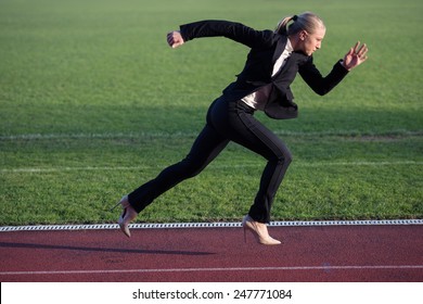 Business Woman In Start Position Ready To Run And Sprint On Athletics Racing Track