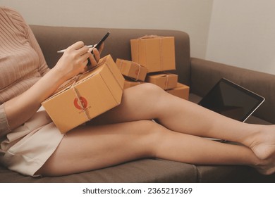 Business woman start up small business entrepreneur SME success .freelance woman working at home with Online Parcel delivery. SME and packaging deliveryconcept - Shutterstock ID 2365219369