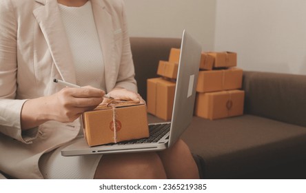 Business woman start up small business entrepreneur SME success .freelance woman working at home with Online Parcel delivery. SME and packaging deliveryconcept - Shutterstock ID 2365219385