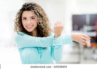 Business Woman Stretching Her Arm At The Office 