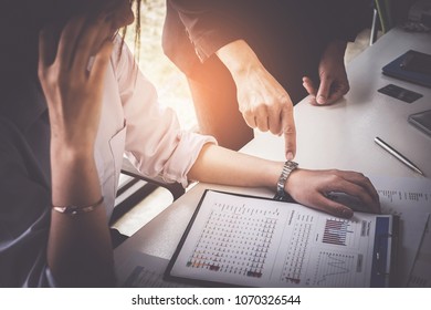 Business Woman Struggling And Her Boss Pointing At Watch To Meet Challenging Deadlines.