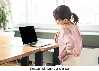 Business Woman Suffering From Stiff Shoulders