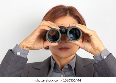 Business Woman In Suit Looking Through Binoculars
