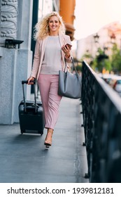 Business Woman With Suitcase Leaving Hotel