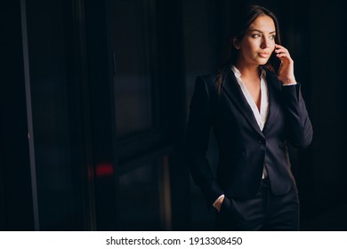 Business Woman Talking On The Phone And Staying Late At Night At The Office