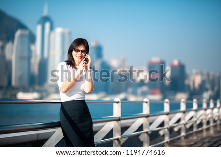 Business woman talking on smart phone in Hong Kong. 