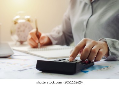 business woman in tax deduction planning concept Calculate tax deduction in 2022, businessman calculates business balance, prepares for tax deduction. - Shutterstock ID 2051162624