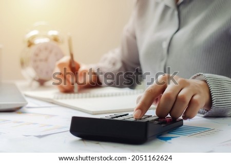 business woman in tax deduction planning concept Calculate tax deduction in 2022, businessman calculates business balance, prepares for tax deduction.