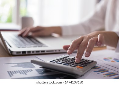 Business Woman Thinking Account, Using Calculator And Laptop On Desk 