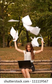 Business Woman Throwing Paper In The Air In Park