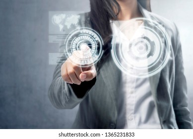 Business woman touch a circle on virtual screen which display the interface of world map and binary code. Digital technology concept