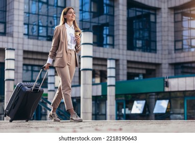 Business woman travel to airport, hotel or office. Portrait of young professional walking in city street with suitcase bag