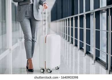 Business Woman With Travel Luggage In Airport, Holding Laptop