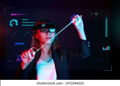 Business woman try vr glasses hololens in the dark room. Portrait of young asian girl experience ar communication. Future technology concept