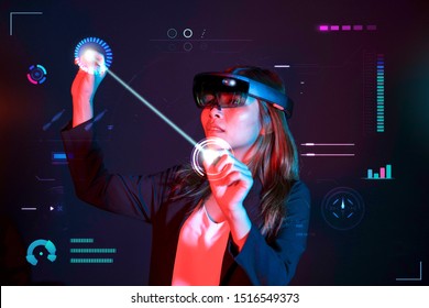 Business woman try vr glasses hololens in the dark room. Young asian girl experience mixed reality. Future technology concept.
