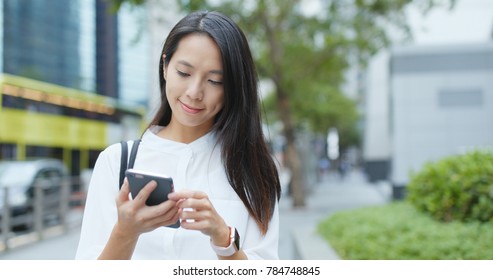 Business woman use of smart phone in city 