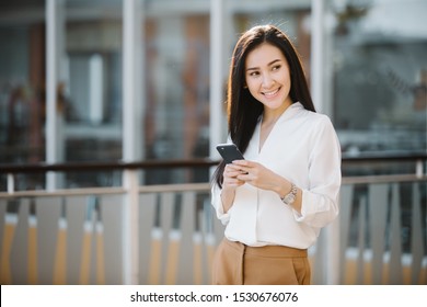 Business Woman Uses Smart phone on the street