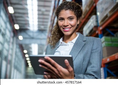 Business Woman Using Her Tablet In A Warehouse