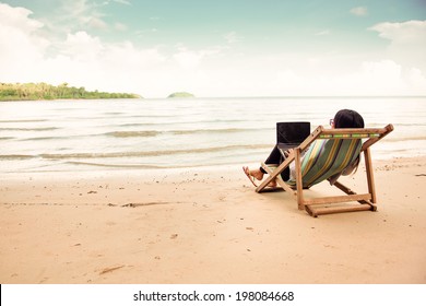 Business Woman Using A Laptop Beside The Beach