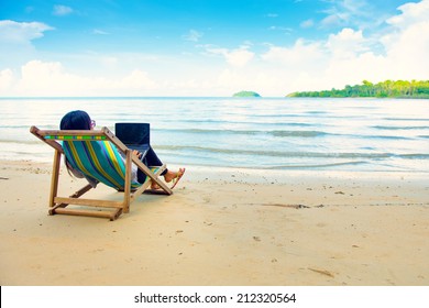 Business Woman Using A Laptop Beside The Beach