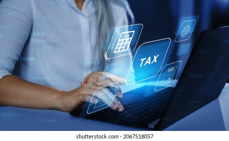 Business Woman Using A Laptop With Digital Graphic Screen To Complete Income Tax Form Online. Financial Research,government Taxes And Calculation Tax Return Concept. Tax Time