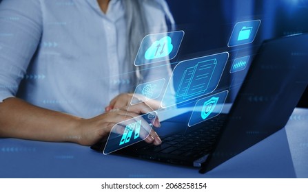Business woman using a laptop with digital graph to document management. Software online documentation database and digital file storage system and file access concept. - Shutterstock ID 2068258154